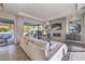 Bright living room featuring a fireplace, TV, neutral furniture, and sliding glass doors to backyard at 10 Sugarberry Ln, Las Vegas, NV 89135