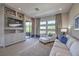 Living room with built-ins, modern sofa and chairs, and access to outdoor balcony at 10 Sugarberry Ln, Las Vegas, NV 89135