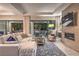 Open floor plan living room with comfortable seating, fireplace, and backyard access at 10 Sugarberry Ln, Las Vegas, NV 89135