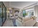 Open living room with sliding doors to back yard, fireplace, television, and lots of light at 10 Sugarberry Ln, Las Vegas, NV 89135