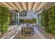 Outdoor dining area with modern furniture and shade, perfect for entertaining at 10 Sugarberry Ln, Las Vegas, NV 89135