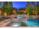 Sparkling swimming pool with a raised spa featuring decorative tile, perfect for relaxation and entertainment at 10 Sugarberry Ln, Las Vegas, NV 89135