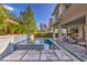 Lush backyard featuring a modern pool, outdoor seating and well-maintained landscaping at 10 Sugarberry Ln, Las Vegas, NV 89135
