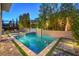 Backyard swimming pool and spa surrounded by manicured landscaping, creating a private outdoor oasis at 10 Sugarberry Ln, Las Vegas, NV 89135