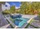 Swimming pool with lush landscaping and brick and grass accents around the pool area at 10 Sugarberry Ln, Las Vegas, NV 89135