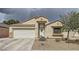 Charming single-story home featuring a two-car garage, neutral stucco, and low maintenance desert landscaping at 1010 Christopher View Ave, North Las Vegas, NV 89032