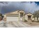 Charming single-story home featuring a two-car garage, neutral stucco, and low maintenance desert landscaping at 1010 Christopher View Ave, North Las Vegas, NV 89032