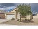 Charming single-story home featuring a two-car garage, neutral stucco, and low maintenance desert landscaping at 1010 Christopher View Ave, North Las Vegas, NV 89032