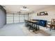 Finished garage space featuring a large door, accent rug, high top table with chairs, and stylish seating at 1010 Christopher View Ave, North Las Vegas, NV 89032