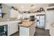 Bright kitchen featuring white cabinets, butcher block island, stainless steel appliances, and tile floors at 1010 Christopher View Ave, North Las Vegas, NV 89032