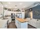 Bright kitchen featuring white cabinets, butcher block island, stainless steel appliances, and tile floors at 1010 Christopher View Ave, North Las Vegas, NV 89032