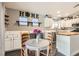 Cozy kitchen featuring white cabinetry, butcher block island, and dining area at 1010 Christopher View Ave, North Las Vegas, NV 89032