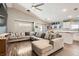 Spacious living room featuring a large sectional sofa, tile floors, and an adjoining eat-in kitchen at 1010 Christopher View Ave, North Las Vegas, NV 89032