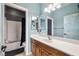 A bright bathroom with a single sink vanity, a large mirror, and a shower-tub combo at 1131 S Blagg Rd, Pahrump, NV 89048