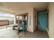 Welcoming covered entryway with seating and a colorful front door at 1131 S Blagg Rd, Pahrump, NV 89048