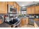 The kitchen features stainless steel appliances, wooden cabinets and tiled backsplash at 1131 S Blagg Rd, Pahrump, NV 89048