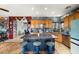 The eat-in kitchen has a spacious island with seating and is accented by custom decor and stainless steel appliances at 1131 S Blagg Rd, Pahrump, NV 89048