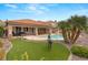 Well-maintained backyard with artificial grass, pool, and covered patio, great for Gathering gatherings at 1303 Panini Dr, Henderson, NV 89052