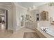 Bright and airy bathroom with a tub, vanity, and glass shower at 1303 Panini Dr, Henderson, NV 89052