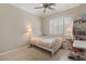 Bedroom featuring a bed, large window with shutters, and bookcase stocked with books and plush toys at 1303 Panini Dr, Henderson, NV 89052