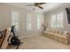A light-filled bedroom with plantation shutters on the windows and exercise equipment at 1303 Panini Dr, Henderson, NV 89052