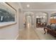 Hallway featuring archways, neutral walls, tiled flooring, and views of dining and front door at 1303 Panini Dr, Henderson, NV 89052