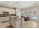 Charming kitchen island with granite countertop, pendant lighting, and a view to the refreshing pool at 1303 Panini Dr, Henderson, NV 89052