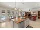 Open-concept kitchen with a central island, stainless appliances, and views of the living area at 1303 Panini Dr, Henderson, NV 89052
