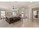 Bright living room with neutral walls, carpet, ceiling fan and multiple windows at 1303 Panini Dr, Henderson, NV 89052