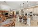 An open-concept space featuring a kitchen island, living room, and hardwood furniture at 1303 Panini Dr, Henderson, NV 89052