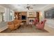 Elegant living room featuring a cozy fireplace, built-in shelves, and comfortable seating arrangement at 1303 Panini Dr, Henderson, NV 89052