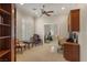 Bright home office with a ceiling fan, custom shutters, and built-in shelves and cabinets at 1303 Panini Dr, Henderson, NV 89052