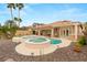 Backyard pool and spa with rock landscaping and covered patio, creating a relaxing outdoor oasis at 1303 Panini Dr, Henderson, NV 89052