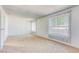 Sunlit bedroom offers neutral carpet, bright white walls and two large windows at 1501 Living Desert Dr # A, Las Vegas, NV 89119