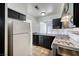 Efficient kitchen layout with classic appliances, dark cabinets and convenient breakfast bar pass-through at 1501 Living Desert Dr # A, Las Vegas, NV 89119