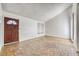 Bright living room featuring unique brick flooring, a front door and large windows allowing natural light at 1501 Living Desert Dr # A, Las Vegas, NV 89119