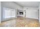 Spacious living room with brick floors leading to kitchen and dining area, illuminated by natural light at 1501 Living Desert Dr # A, Las Vegas, NV 89119
