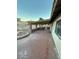 A charming backyard has a covered patio with brick pillars, a brick-paved area, and well-maintained landscaping at 1617 Joshua Tree Ct, Las Vegas, NV 89108