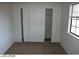 A simple bedroom features neutral carpet and walls, a closet, and a window for natural light at 1617 Joshua Tree Ct, Las Vegas, NV 89108
