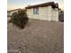 Side exterior of a single-story home with gravel landscaping and a red tile roof at 1617 Joshua Tree Ct, Las Vegas, NV 89108