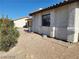 Side exterior of a single-story home with gravel landscaping and a red tile roof at 1617 Joshua Tree Ct, Las Vegas, NV 89108