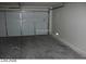 A clean garage with white walls, a concrete floor, and a closed white garage door at 1617 Joshua Tree Ct, Las Vegas, NV 89108