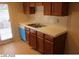 Efficient kitchen layout includes white countertops, wood cabinets, and a side-by-side sink at 1617 Joshua Tree Ct, Las Vegas, NV 89108
