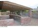 Covered patio featuring brick columns and garden box, brick-paved patio, providing an inviting outdoor space at 1617 Joshua Tree Ct, Las Vegas, NV 89108