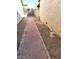 Narrow side yard featuring a brick pathway and low-maintenance gravel landscaping at 1617 Joshua Tree Ct, Las Vegas, NV 89108
