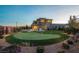 Aerial view of a backyard with a putting green and an outdoor kitchen area in a luxury backyard at 18 Garden Rain Dr, Las Vegas, NV 89135