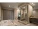 Luxurious bathroom with a soaking tub, glass-enclosed shower, and modern vanities at 18 Garden Rain Dr, Las Vegas, NV 89135