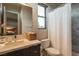 This is a modern bathroom with a shower and a large sink vanity with dark wood cabinets at 18 Garden Rain Dr, Las Vegas, NV 89135