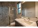 Modern bathroom with a tiled shower, single vanity, and stylish fixtures at 18 Garden Rain Dr, Las Vegas, NV 89135