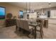 Modern dining room with view to the kitchen and backyard at 18 Garden Rain Dr, Las Vegas, NV 89135